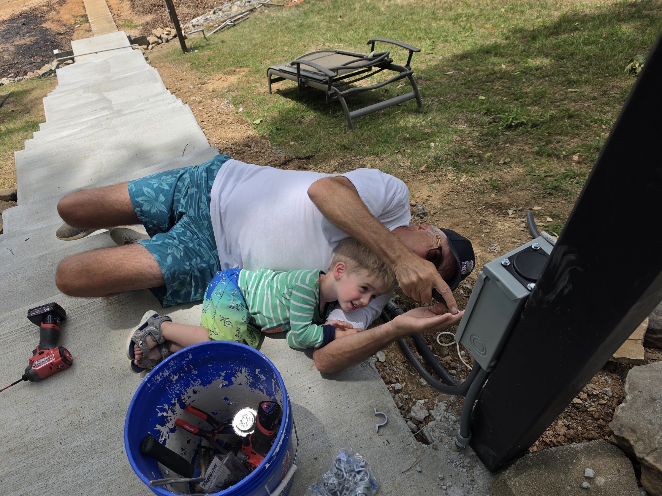 A young member of the Parsons family helping with an install, just like his grandfather did